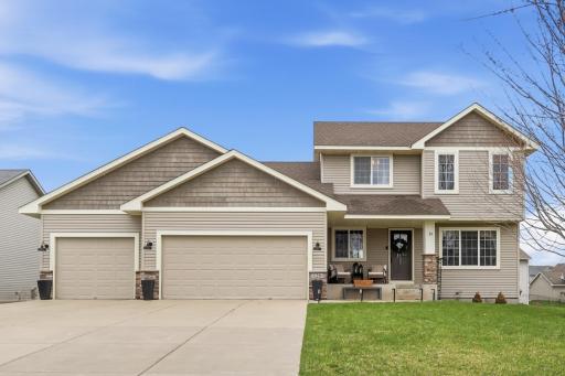 Great curb appeal with welcoming front porch, concrete driveway, and 3-car garage.