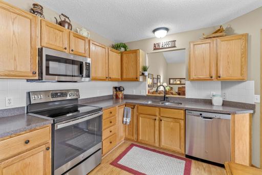 The Kitchen boasts an abundance of cabinet and counter space. Stainless steel appliances and a tile backsplash.