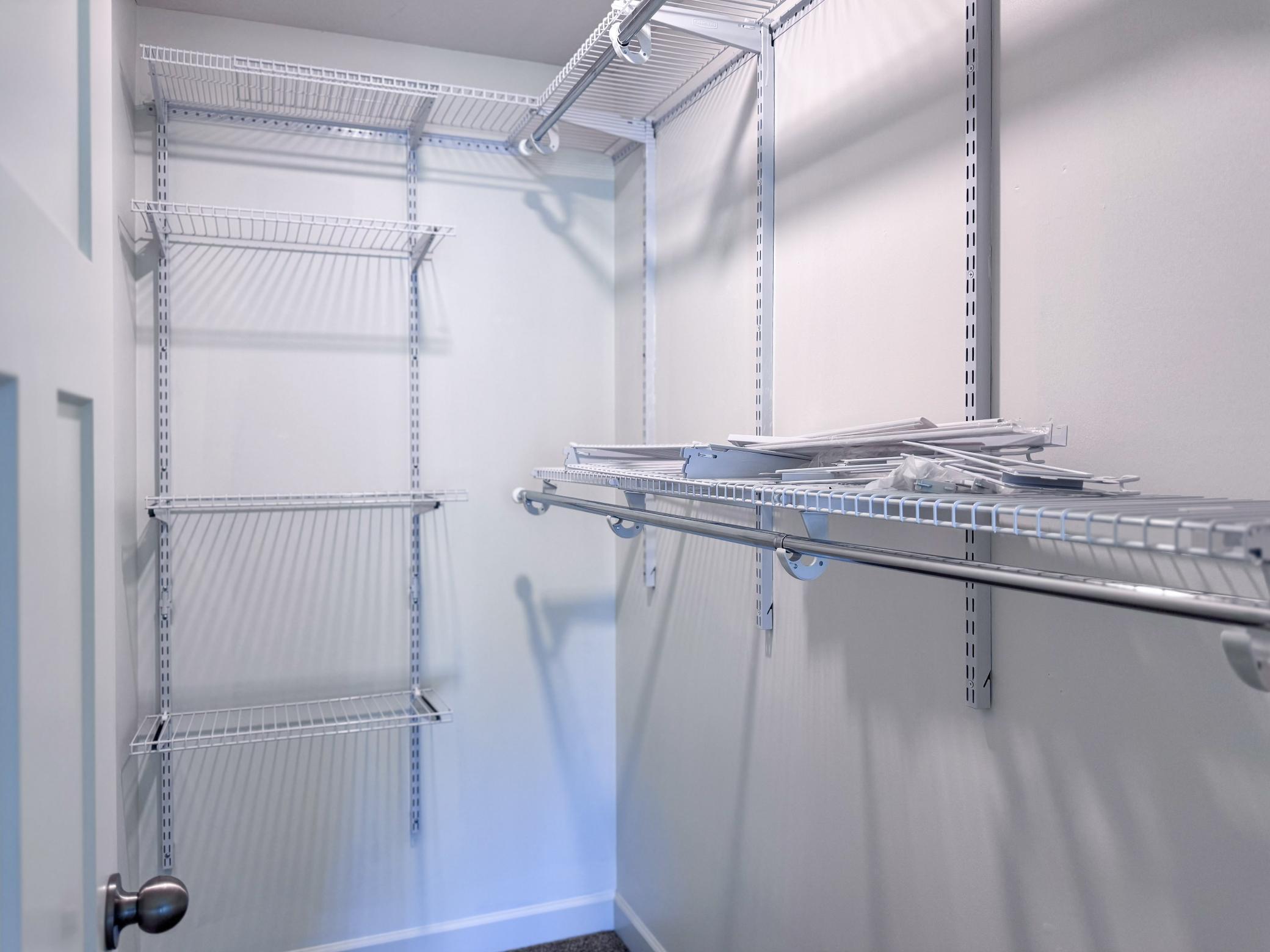 Primary bedroom walk-in closet with organizers