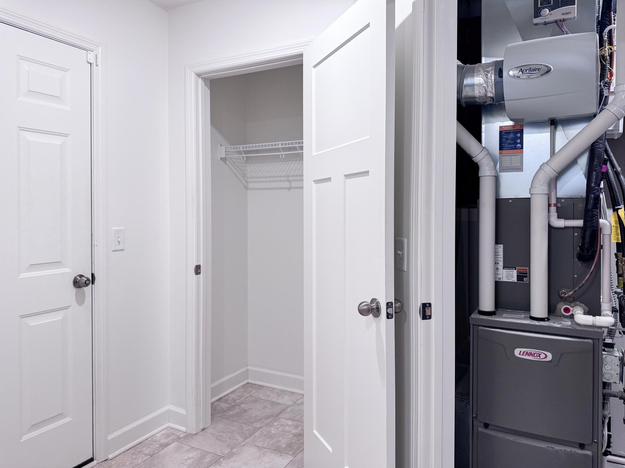 Garage access door, coat closet, and utility closet