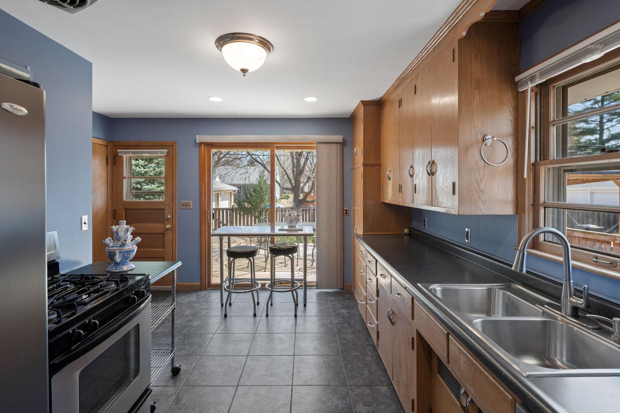 Kitchen features sliding door to easily extend to your outdoor space.