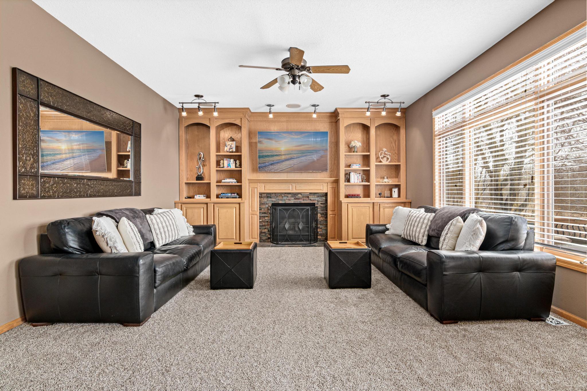 Large family room with bookshelves and cozy gas fireplace