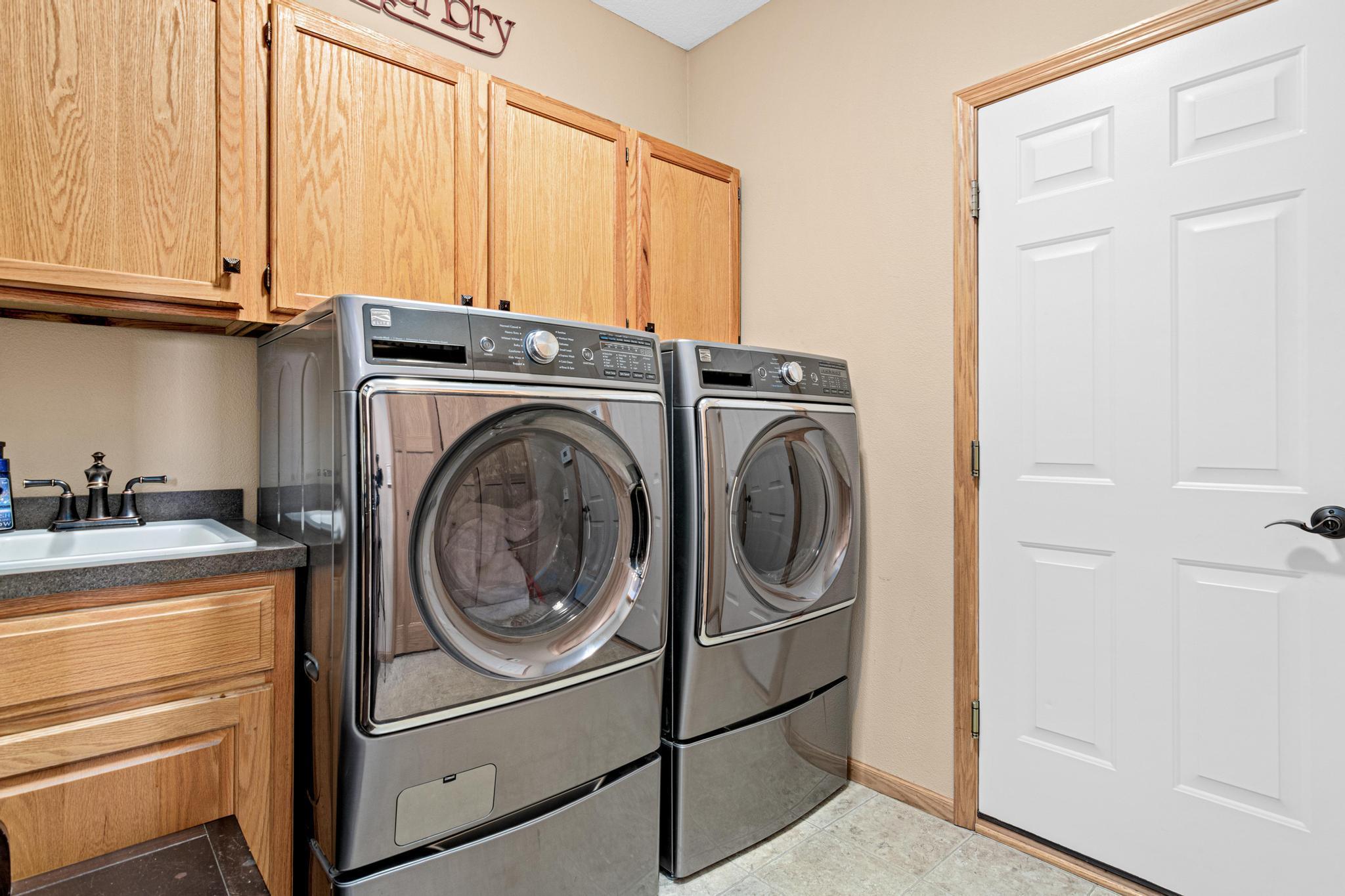 Nice size laundry room w/ sink and front load appliances