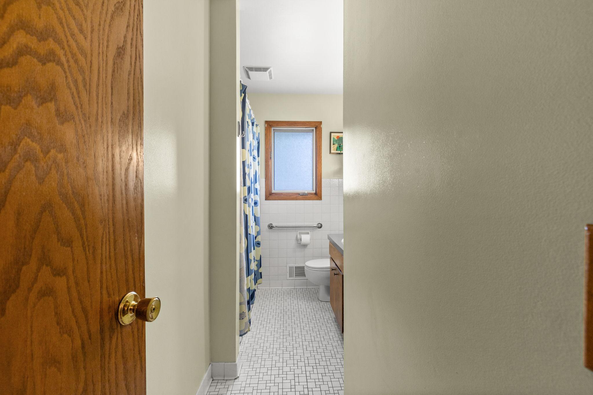 Main floor bath has tiled floor and neutral decor