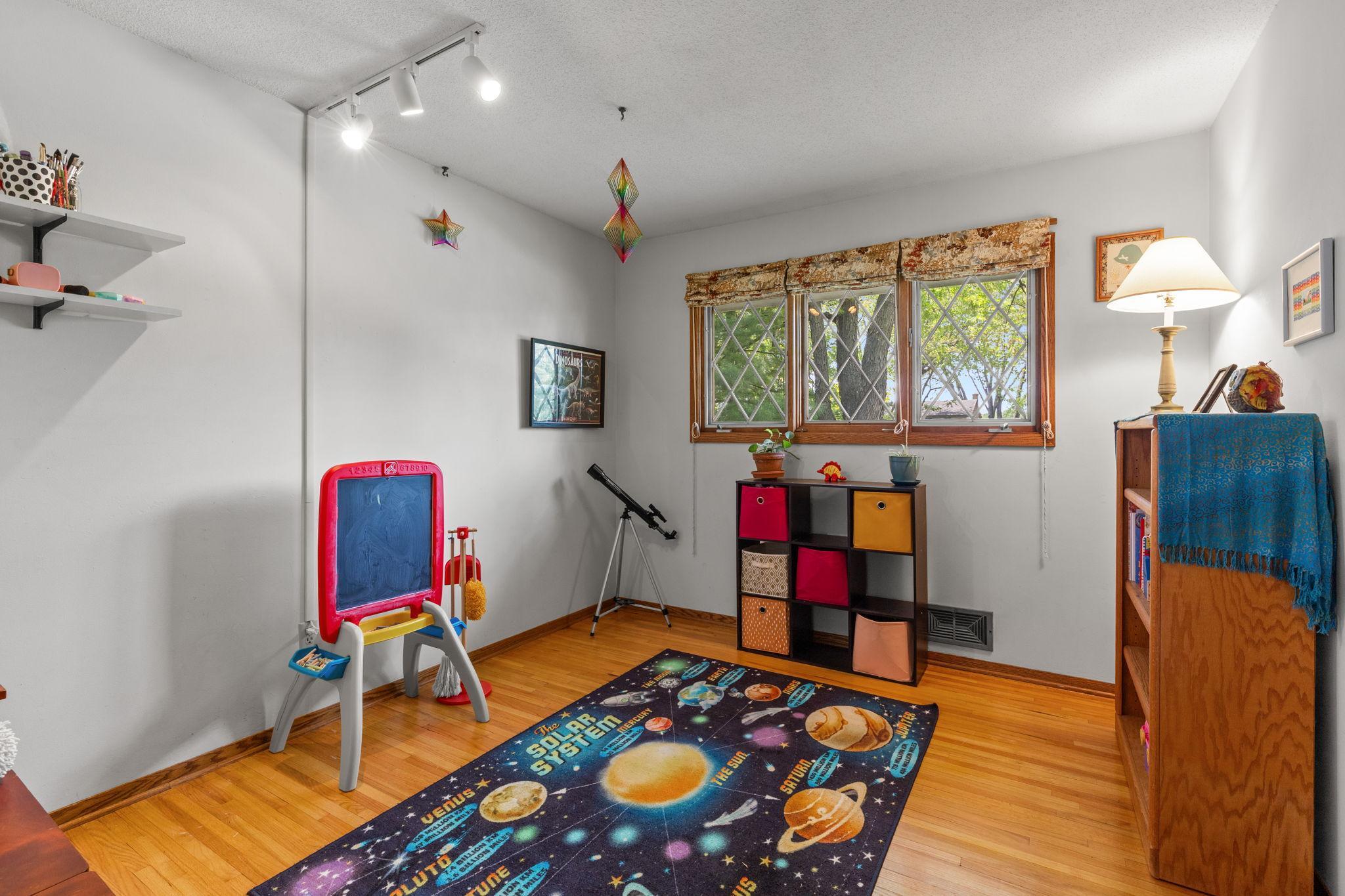 2nd spacious main floor bedroom boasts lovely hardwood floors.