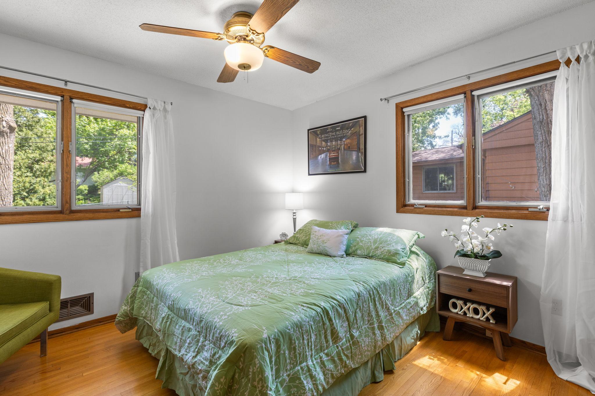 Primary main floor bedroom has neutral decor and double windows for great natural light.