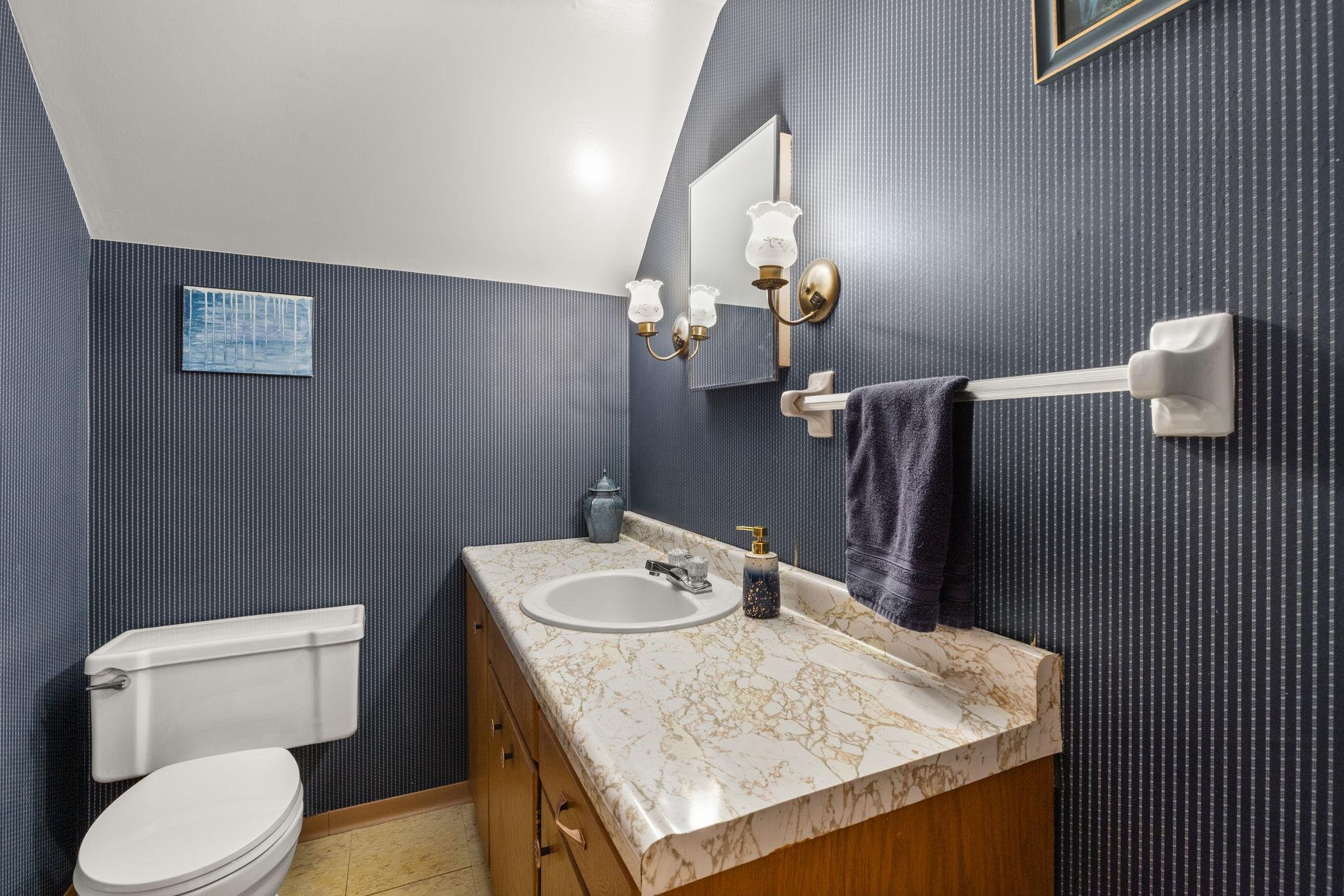Nicely appointed half bath on upper level.