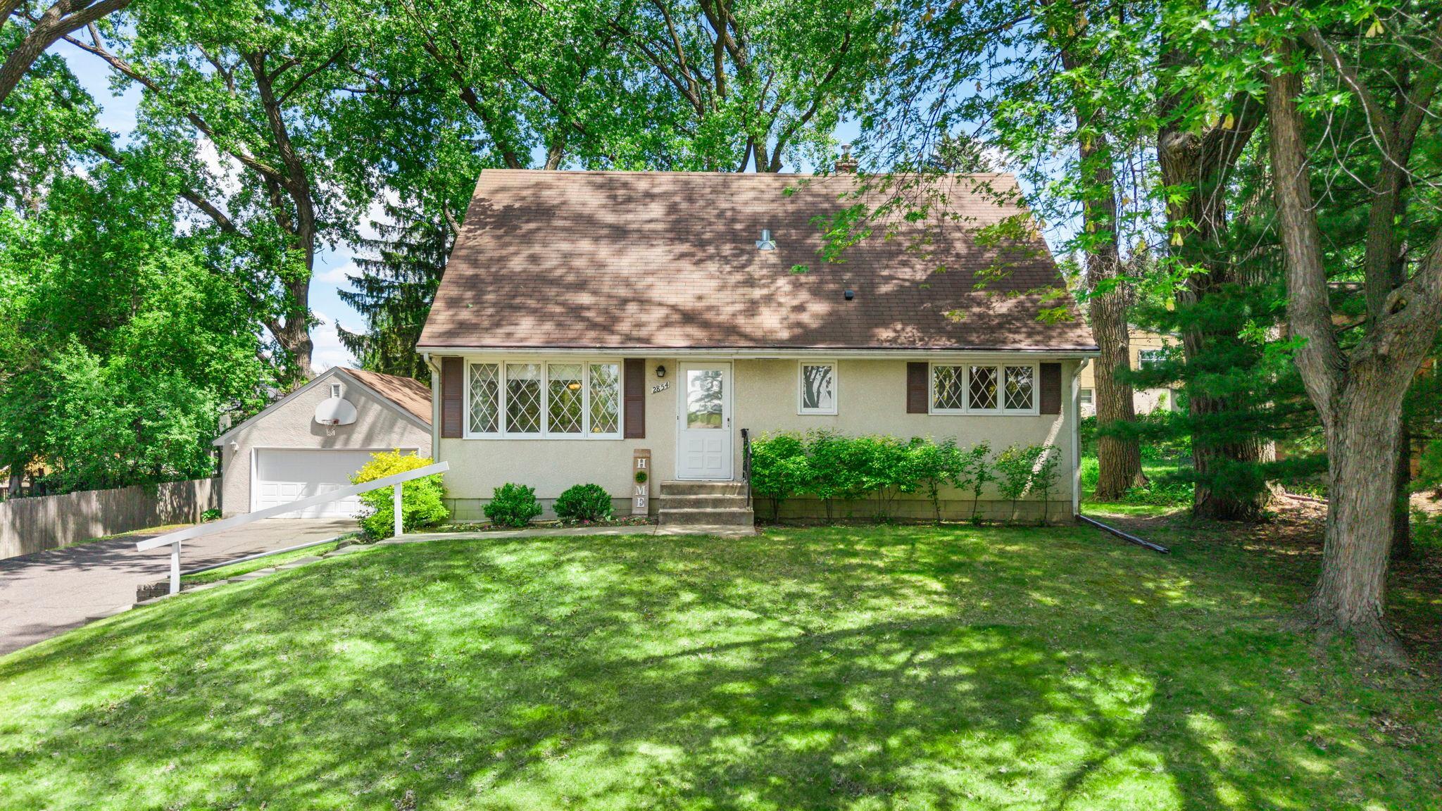 Charming exterior with lush green grass