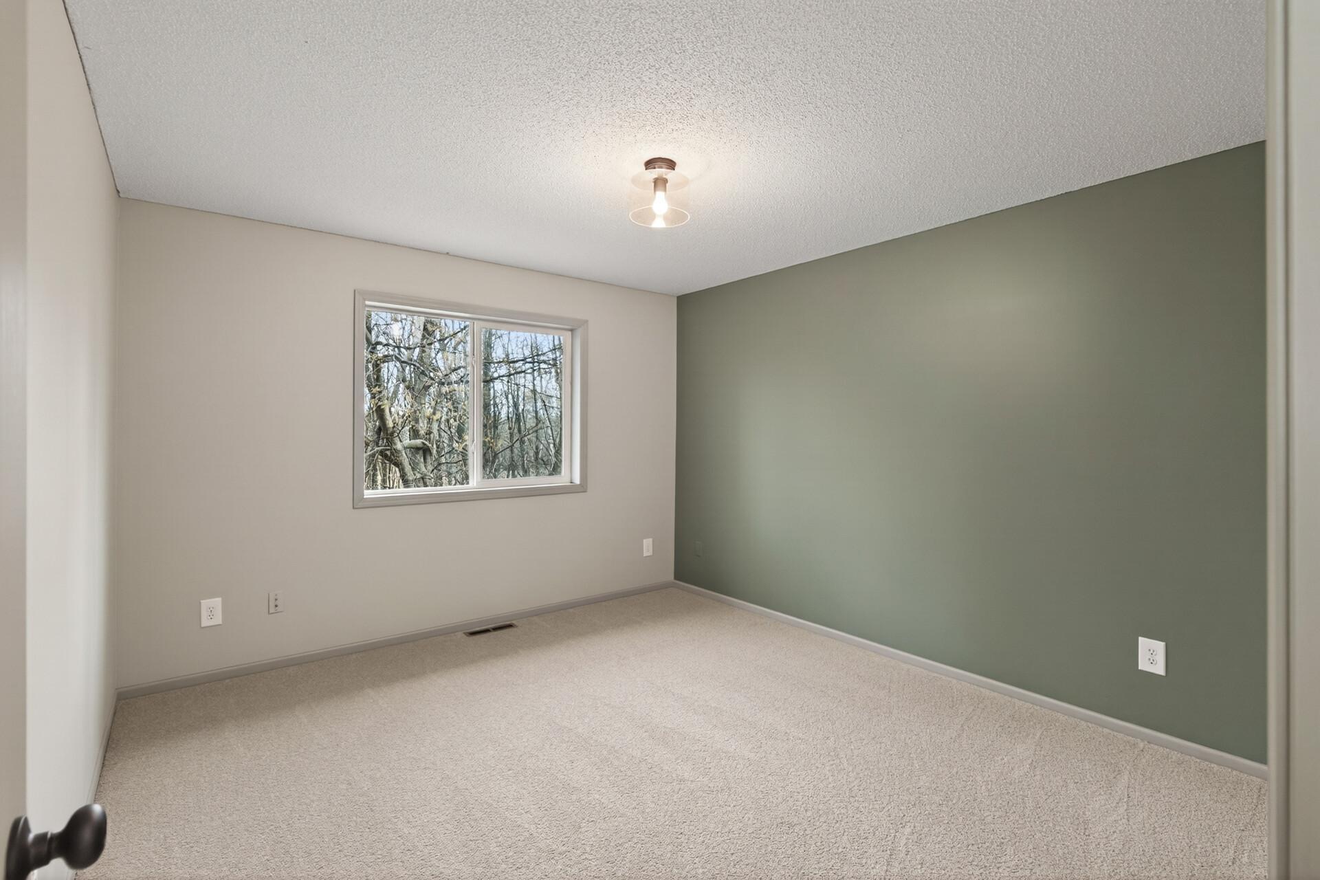 Primary Bedroom with woods view