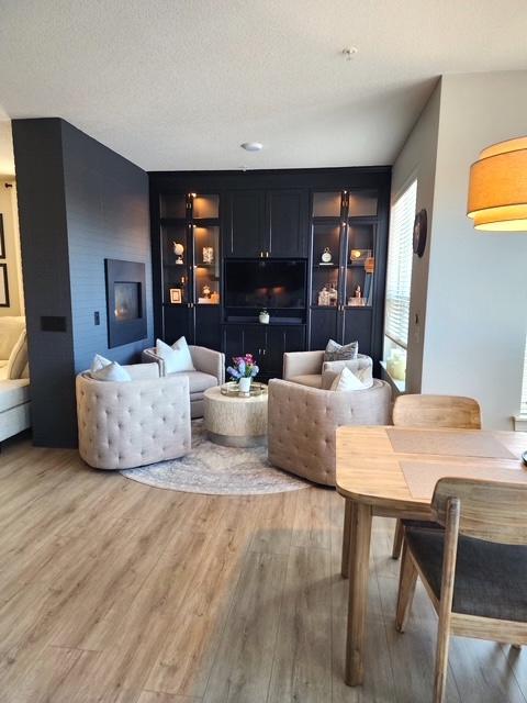 Moody, intimate, and full of character — the parlor room sets the tone with a dark palette, custom built-ins, and a double-sided gas fireplace.