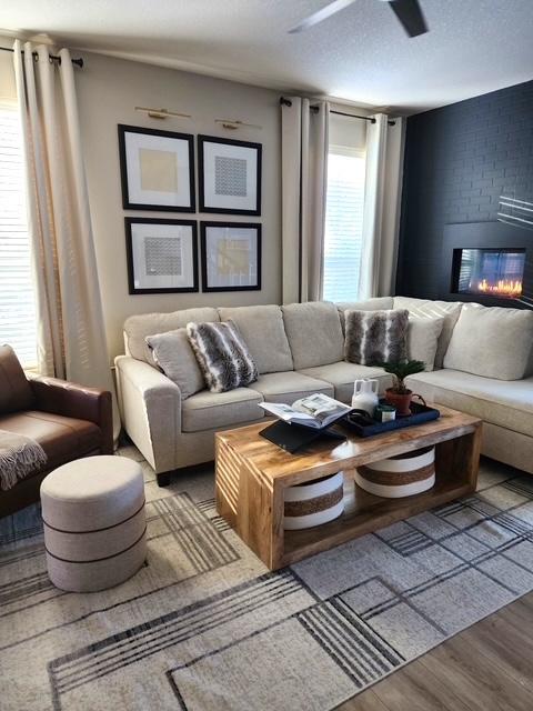 right, open, and anchored by a show-stopping black brick fireplace, this living room strikes the perfect balance between bold and inviting.