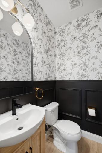 Proof that no space is too small for great design â the powder room features board and batten wall treatment and beautiful wallpaper that make it anything but ordinary.