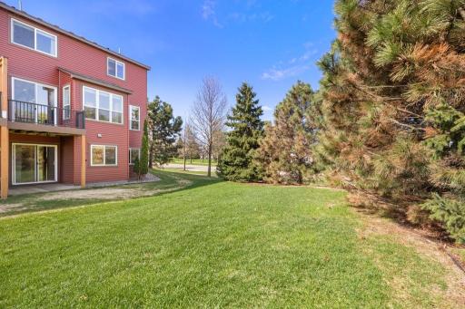 This end unit location pays dividends outside â a spacious yard wrapped in mature trees, creates a private, peaceful outdoor escape that feels entirely your own.