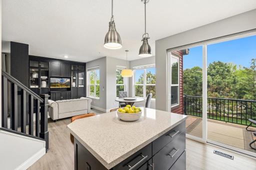 With generous counter space, abundant cabinetry, and a center island with breakfast bar seating, the kitchen is as functional as it is inviting.