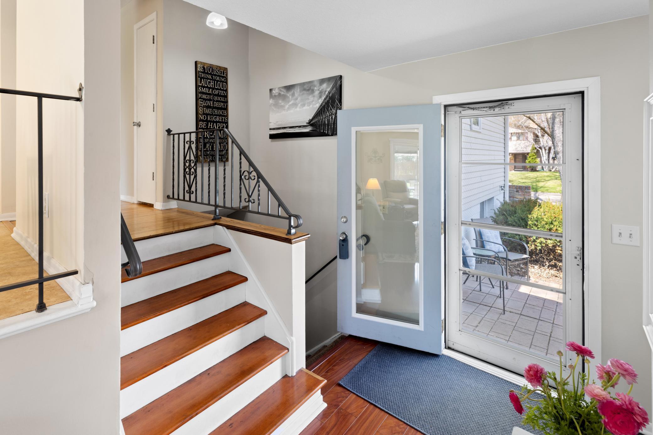 Front entry has a paver patio with a sitting area.