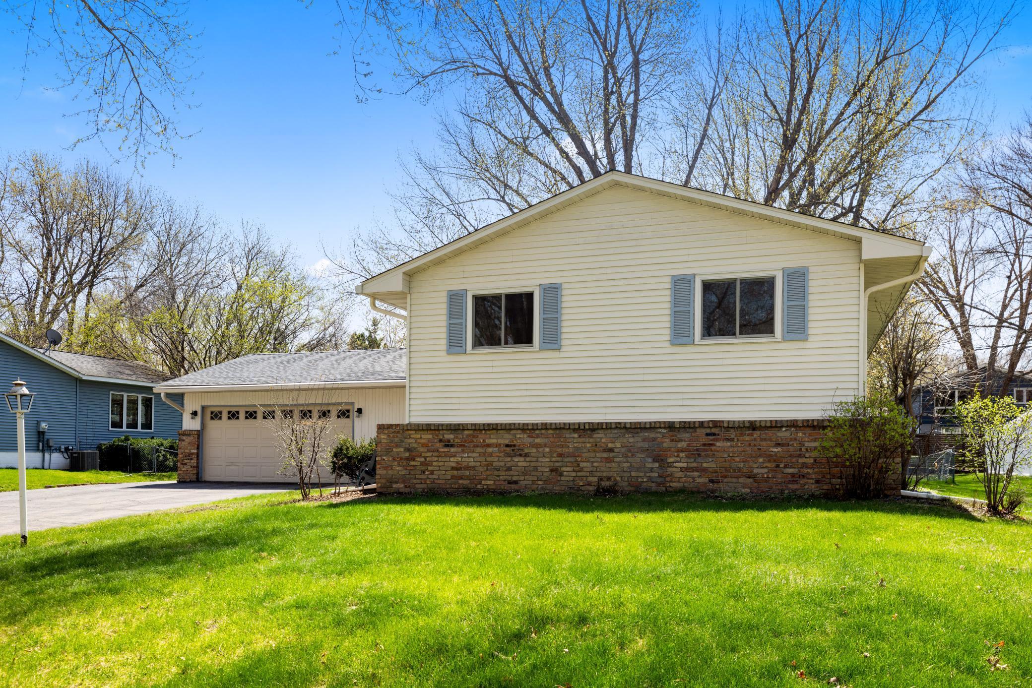 Vinyl siding with brick trim for easy maintenance.