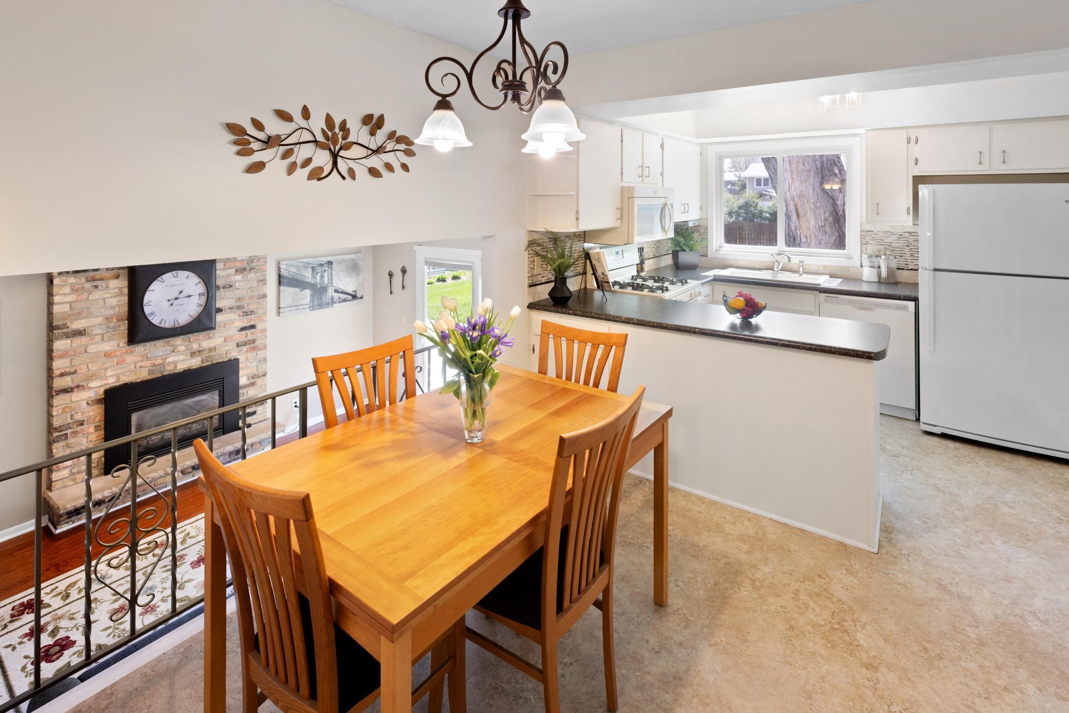 Informal Dining Room adjacent to Kitchen is open to main level Family Room. Kitchen and dining area have fresh, neutral paint.