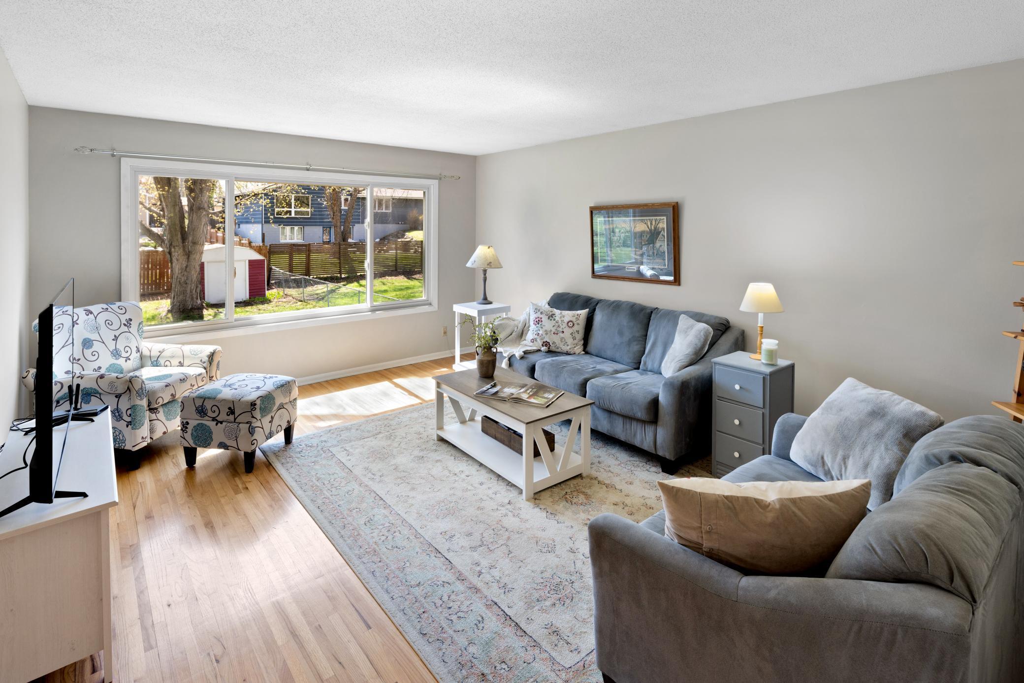 There are beautiful hardwood floors, a huge updated picture window allowing for added light and overlooking the expansive backyard area.