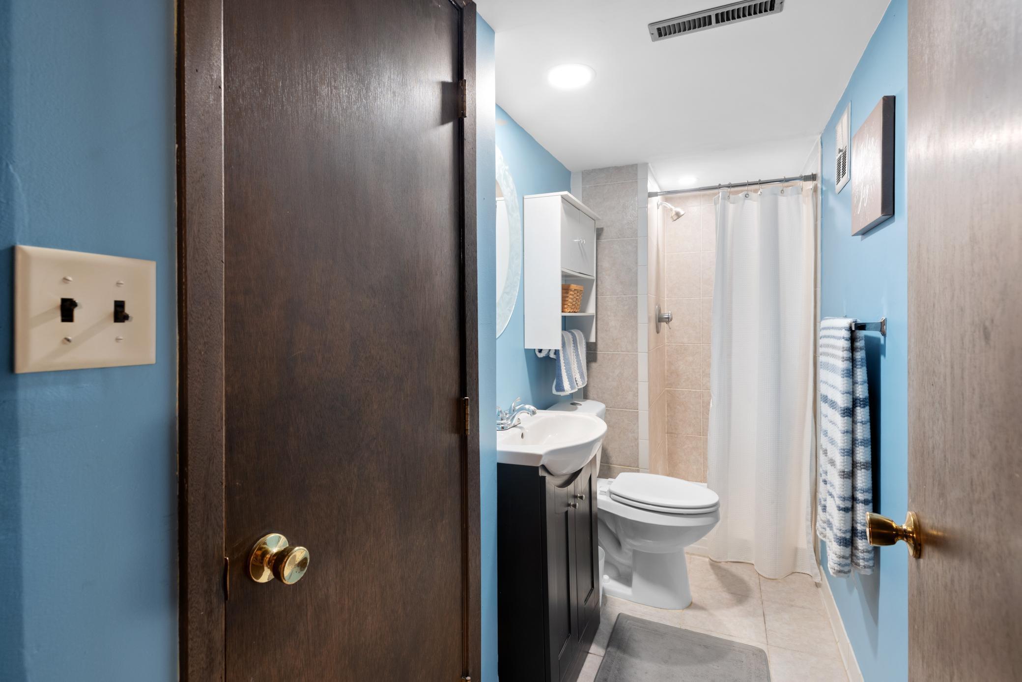 Lower Level 3/4 Bath with ceramic flooring, ceramic tile shower and linen closet!