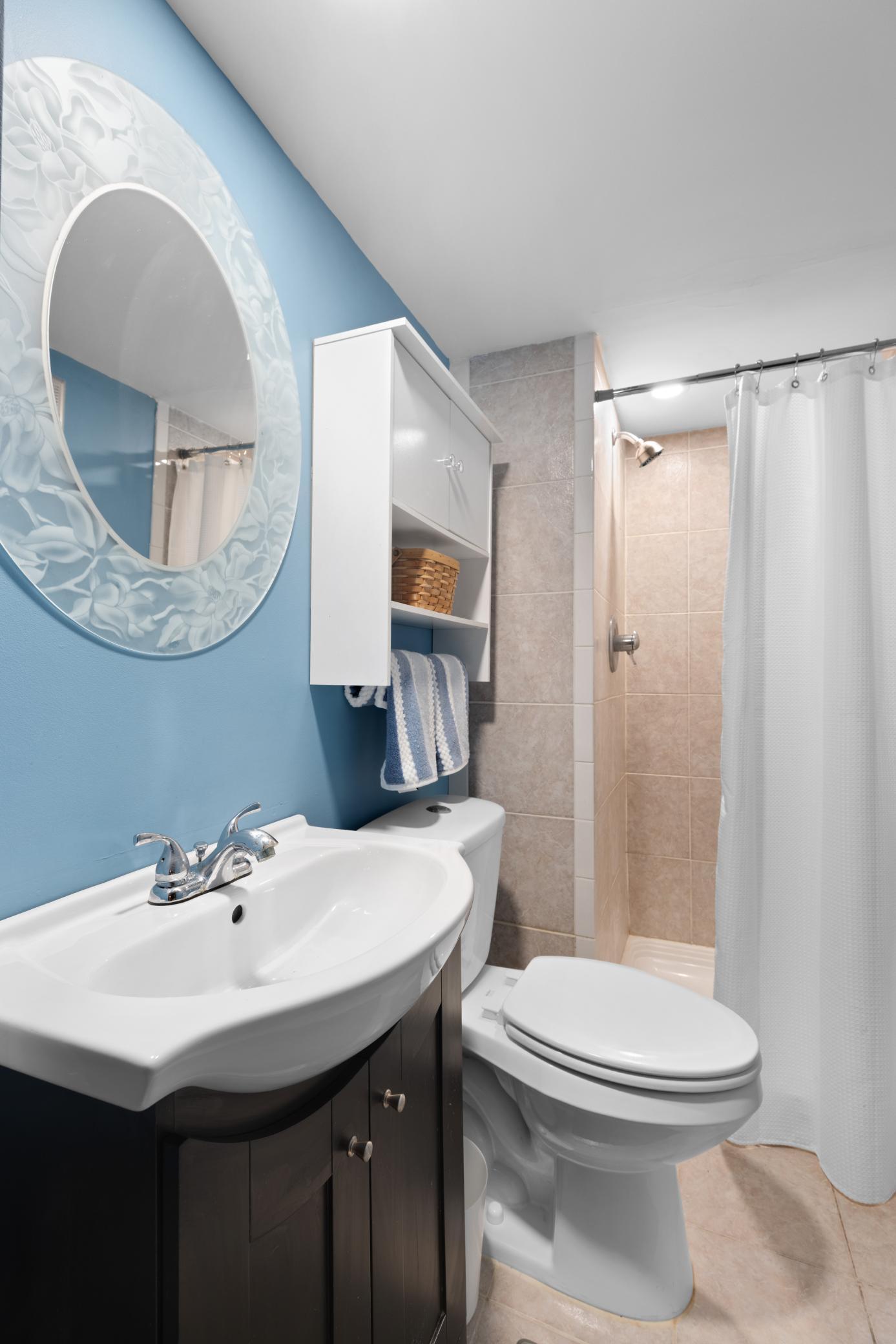 There is an updated vanity with decorative mirror.