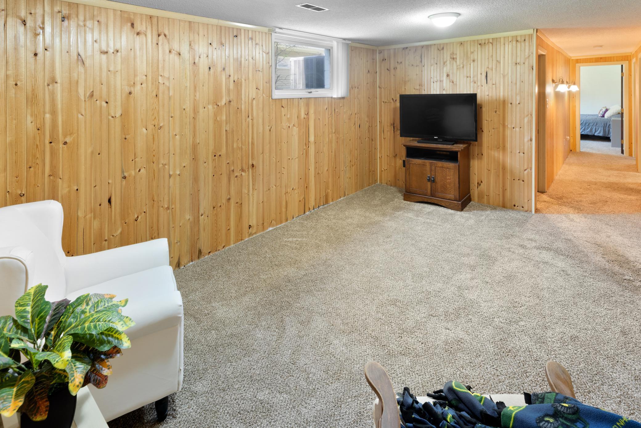 Lower Level has bead board paneling and lighted hallway sconces.