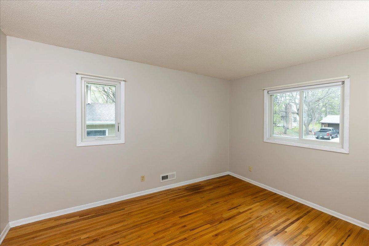 Third Bedroom on Upper Level has updated windows, hardwood flooring and fresh neutral paint.