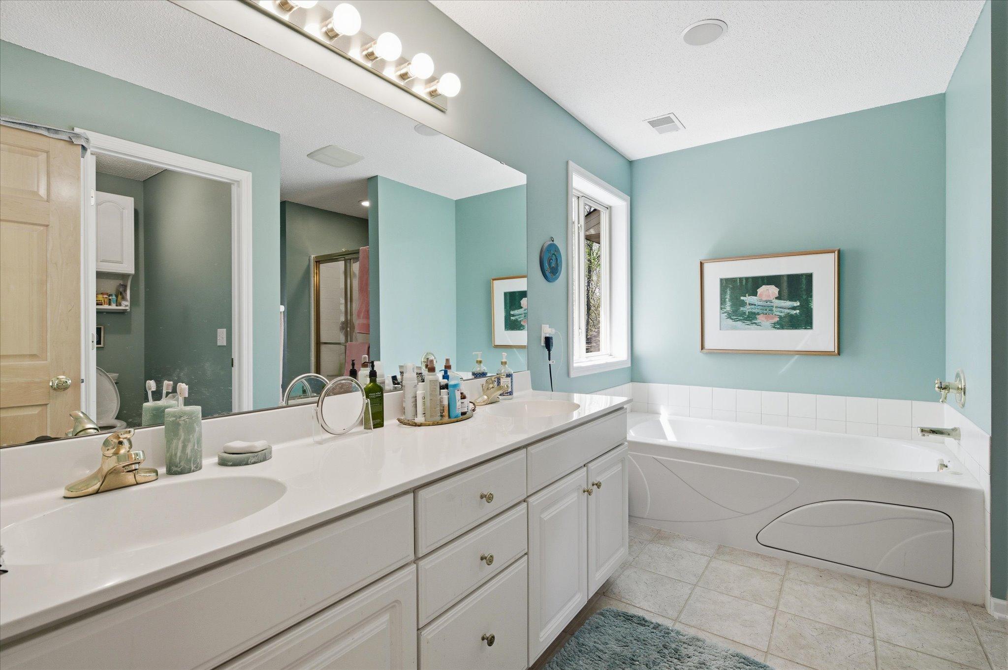 Owner's bath has tub and shower stall