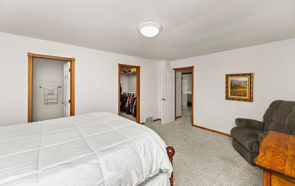 Primary Bedroom. Spacious w/ ensuite, walk-in closet, large windows to backyard.