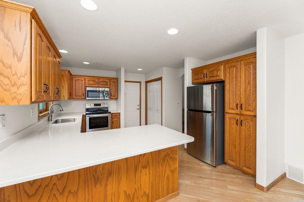 Kitchen offers solid oak cabinets, lots of storage, breakfast bar counter for seating.