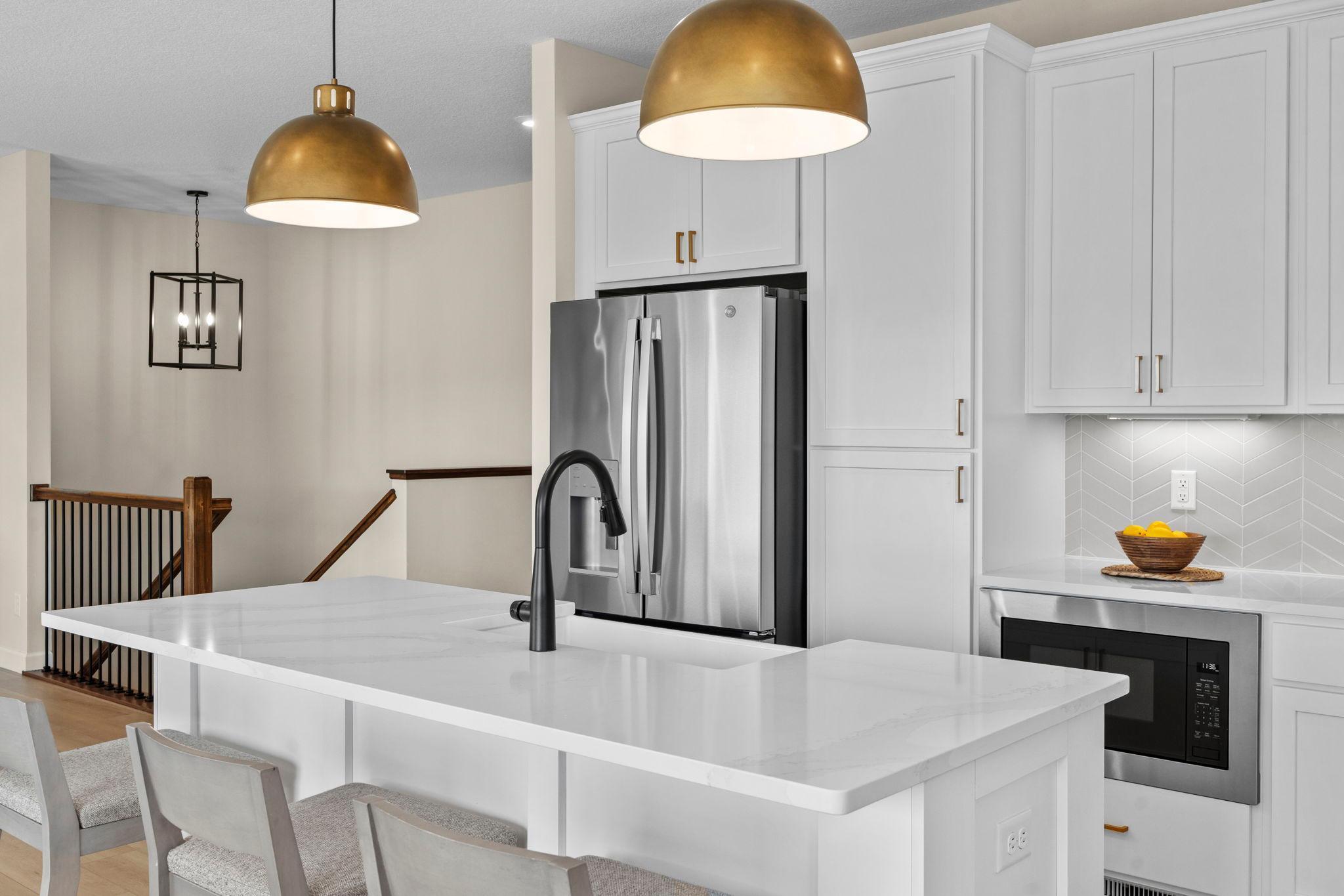 Quartz counters and tile backsplash