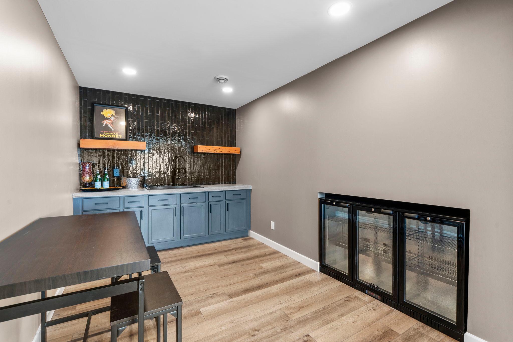 Beverage refrigerator in lower level wet bar area