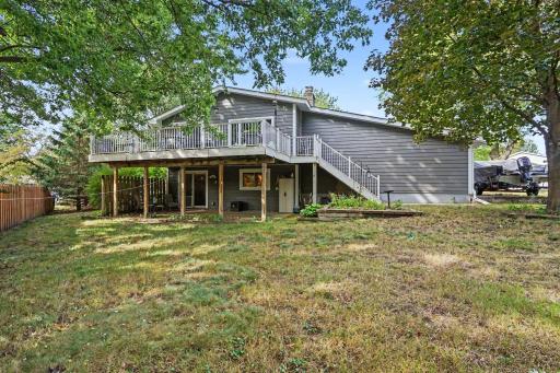 Enjoy the backyard from the patio or the upper level deck~ Notice an additional parking pad for a boat, car or RV