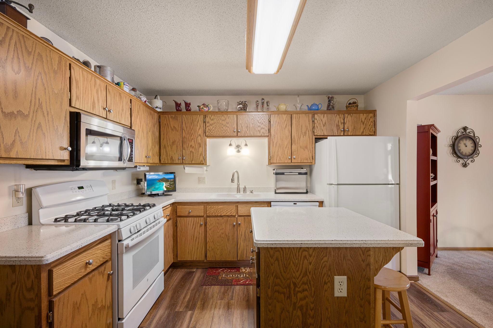 The kitchen is easy access from the garage to bring in groceries a easy task. There is Corian countertop, newer luxury vinyl floor and abundance of cabinets