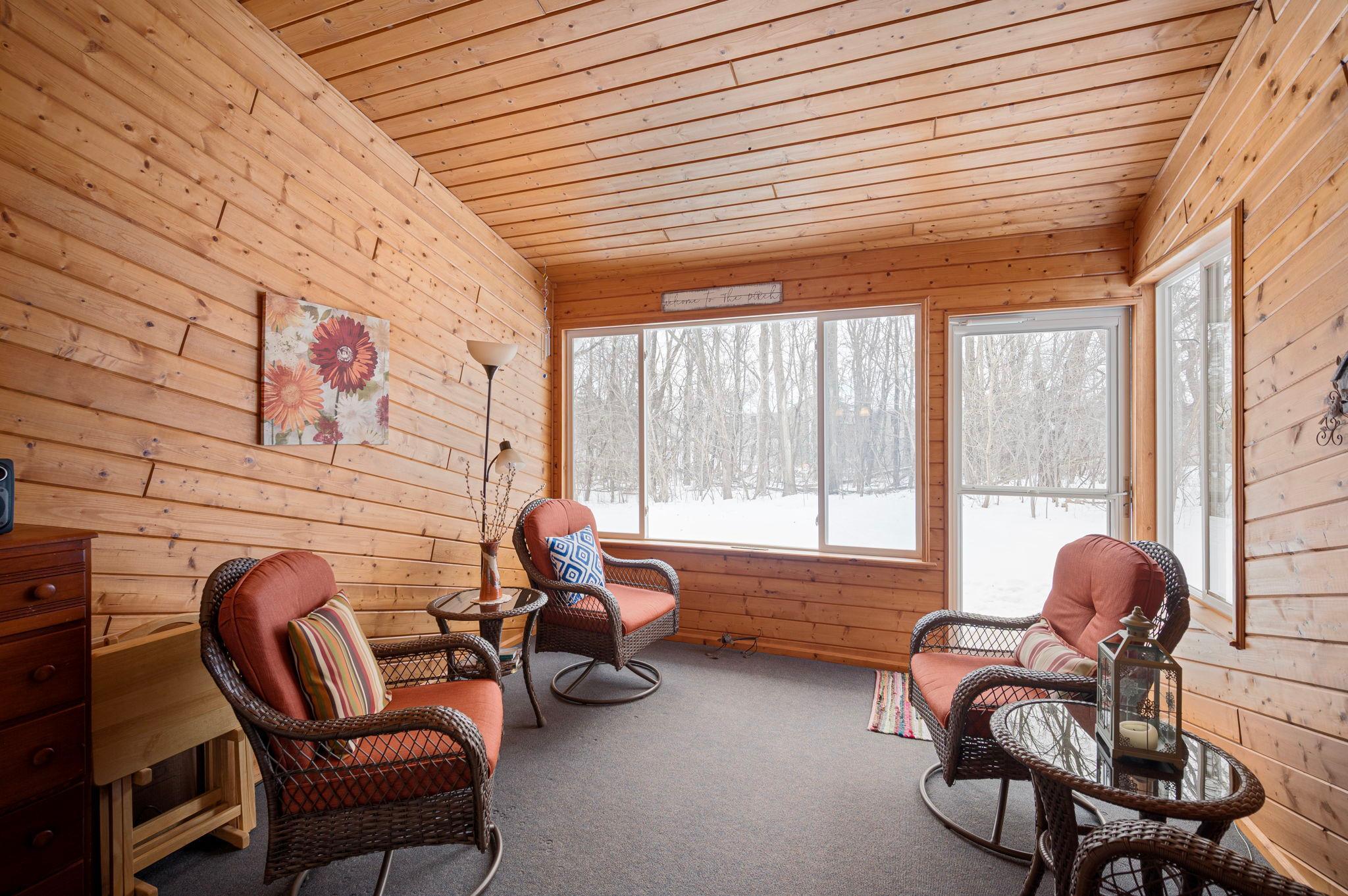 Enjoy the extra space for most of the year in this cozy 3 season porch that is steps away to a very private wooded area. You will enjoy the wild life year round with a wall of windows to bring in the sunshine.