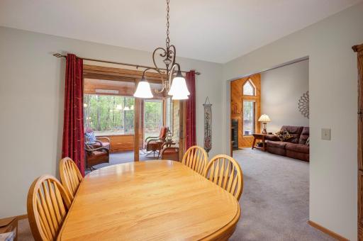The separate dining room is open to kitchen and living room. Walk out to the 3 season porch and private back yard