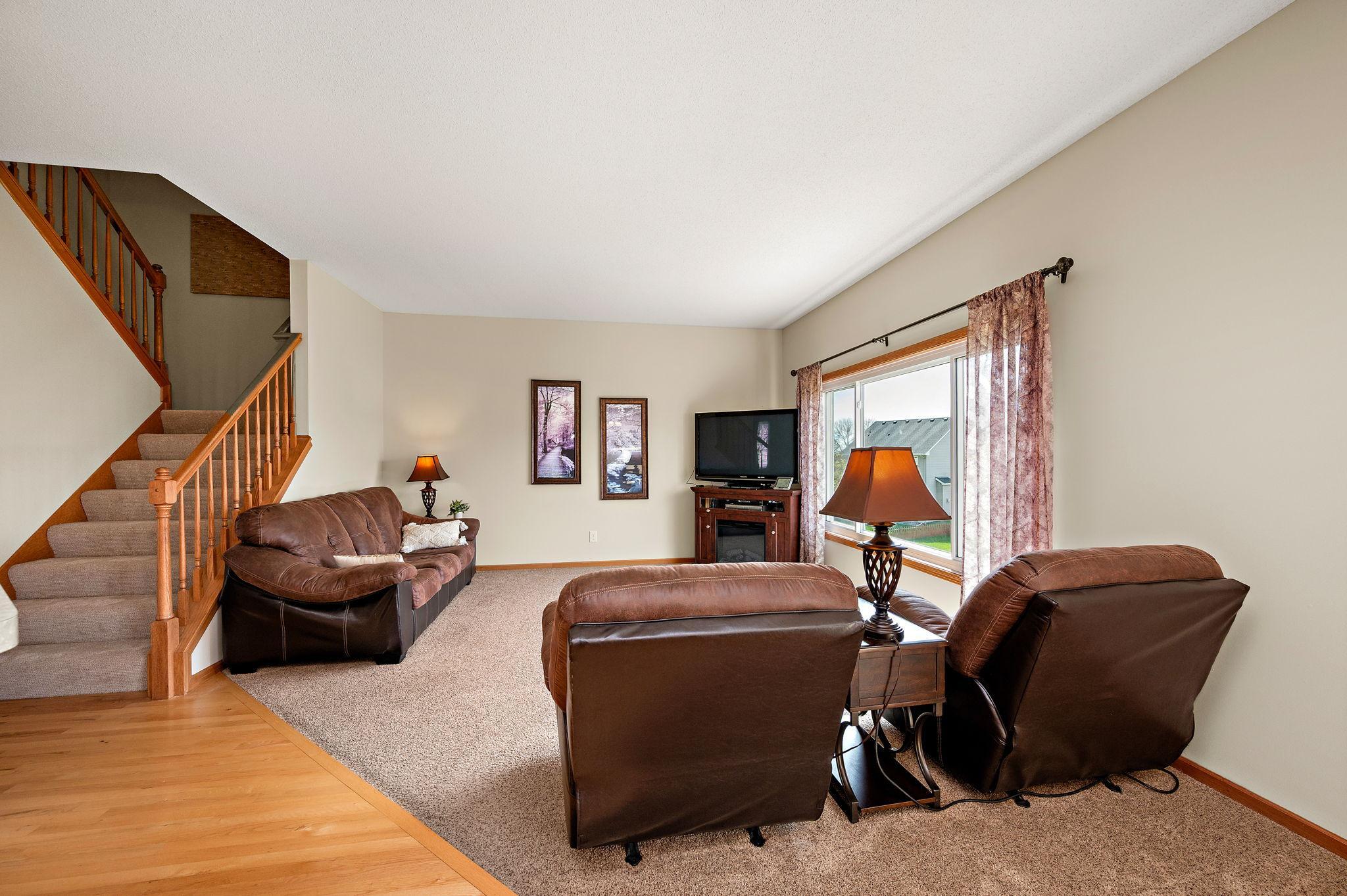 The main level is designed for modern living, boasting a dedicated home office and a spacious living room that flows seamlessly into the heart of the home