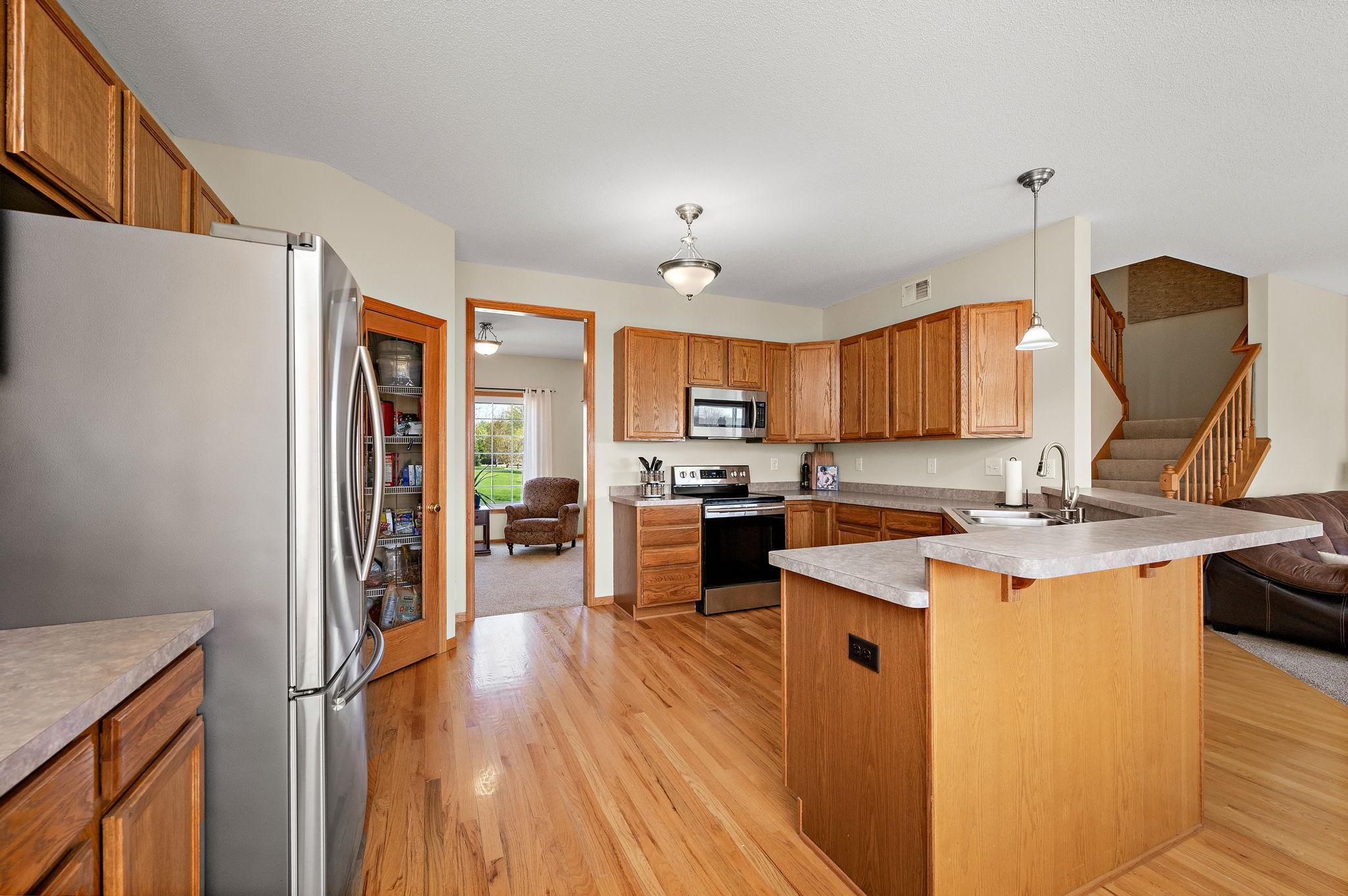 The kitchen features stainless steel appliances, a large breakfast bar and a walk-in pantry!