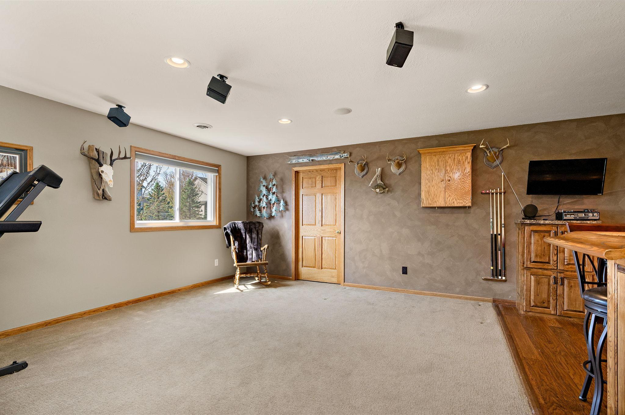 The lower level is built for entertaining, showcasing stylish knock-down ceilings and a custom bar area