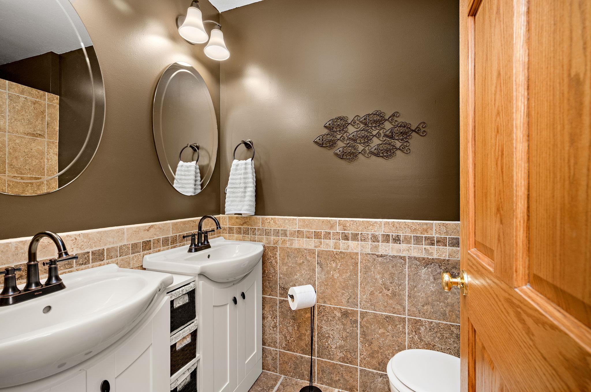 Guests will appreciate the 3/4 bath, which features tile flooring, double sinks, and a beautiful walk-in shower