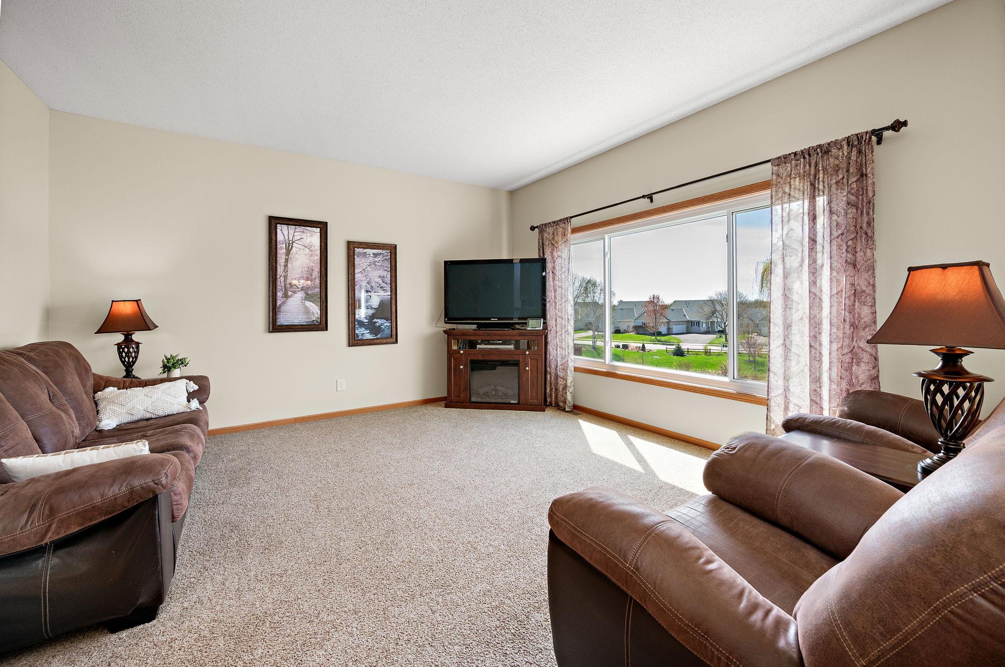 The main level is designed for modern living, boasting a dedicated home office and a spacious living room that flows seamlessly into the heart of the home
