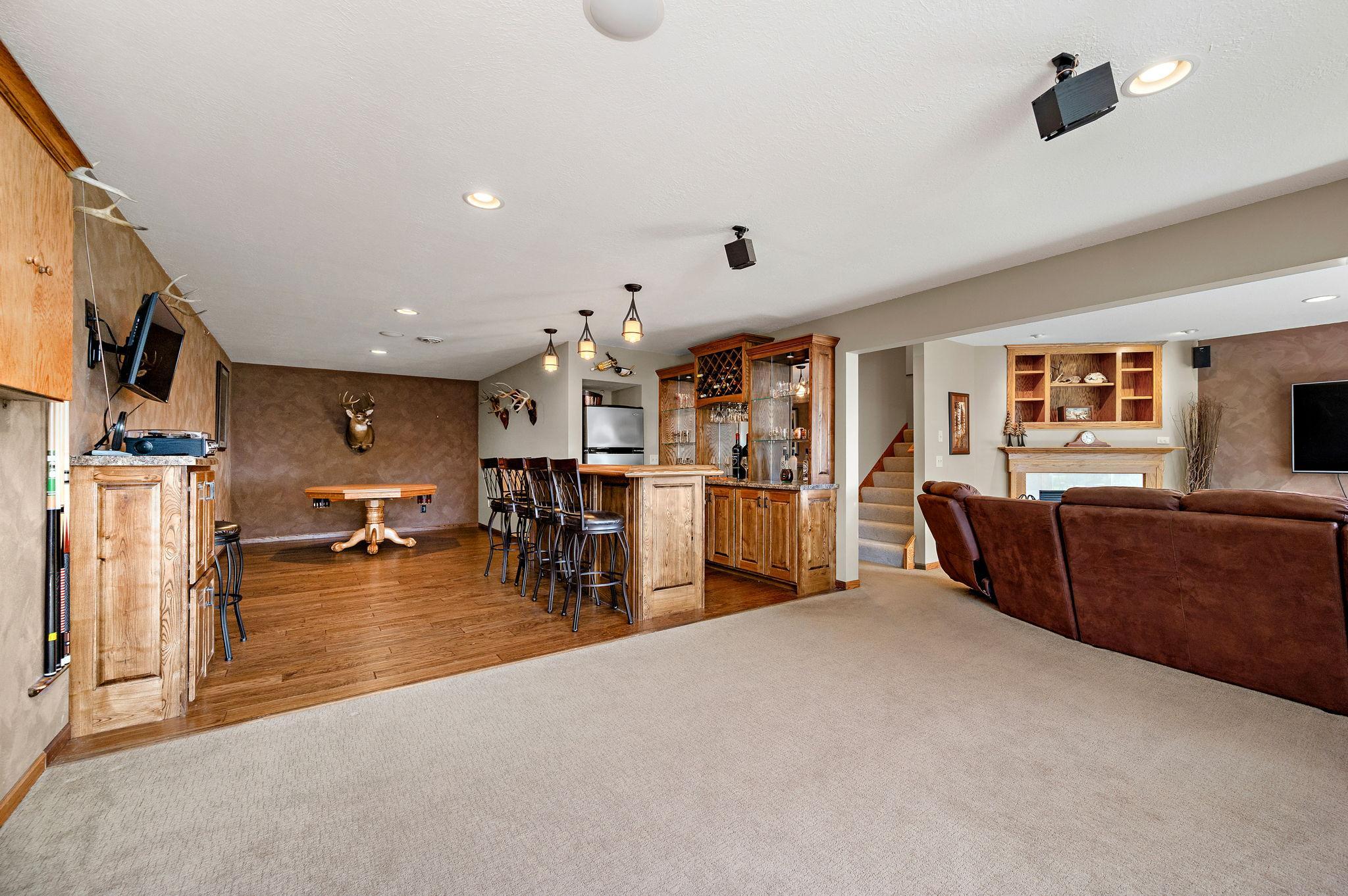 The lower level is built for entertaining, showcasing stylish knock-down ceilings and a custom bar area