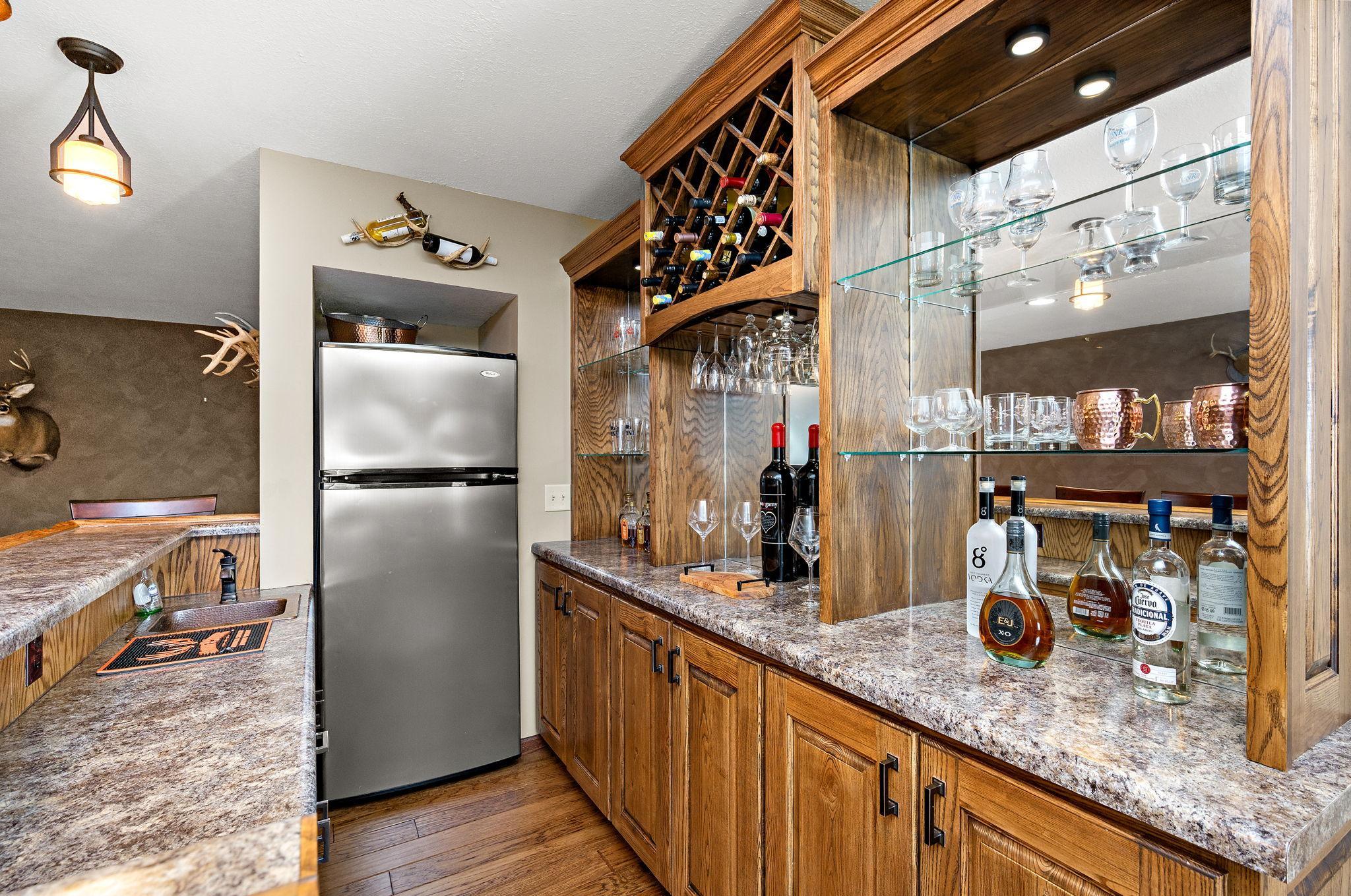 The lower level is built for entertaining, showcasing stylish knock-down ceilings and a custom bar area