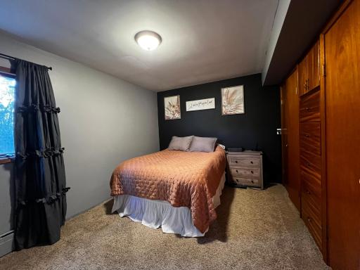 Main Floor Primary Bedroom with Built in Storage Drawers and Closets.