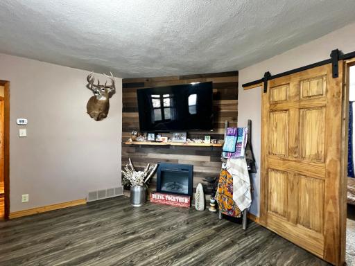 Detail picture of the Accent Wall, Fire Place and Barn Door to 2nd Bedroom!