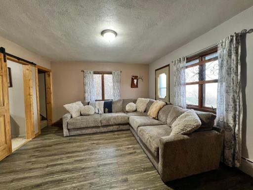Living Room with Bedroom Doorway and Stairway to the Second Floor.