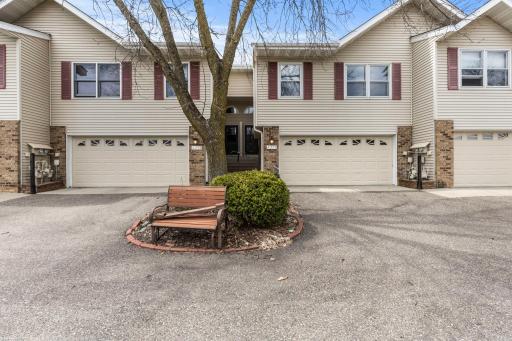 An attached 2-car garage provides direct access to the lower level and includes a built-in workbench and storage shelving.