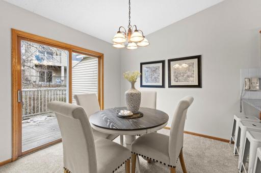 The dining area sits centrally between the living room and kitchen, creating a seamless, well-connected space.