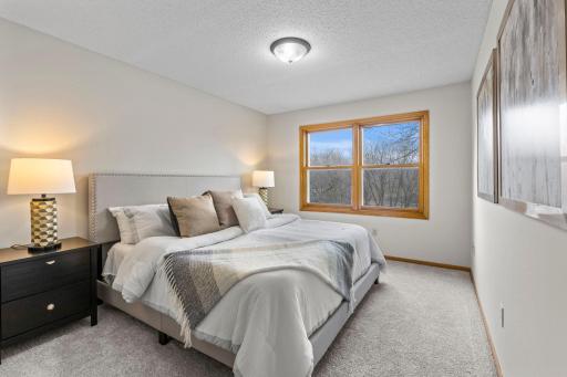 The primary bedroom offers serene views of Heine Pond.