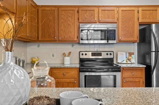 The kitchen features stainless steel appliances throughout.