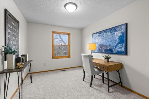 Enjoy pond views from the second upper-level bedroom, complete with a walk-in closet.